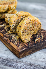 Homemade bread slices with flax, sunflower whole seeds on wooden board. Vegan and vegetarian healthy food.