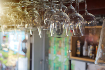 Many wine glasses hang on the counter, restaurant or coffee shop decoration