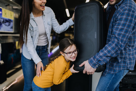 Happy Family Buying Large Music Speaker In Tech Store.