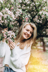 Portrait of a beautiful young woman looking at the park. Portrait of a smiling girl. Happy girl laughing in the park. Spring day. Summer vacation. Lifestyle.