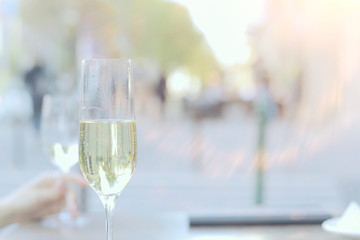 white wine glass in an outdoor cafe, spring view in a restaurant