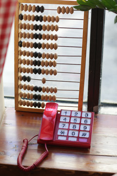 wooden abacus calculating frame on window background close up photo