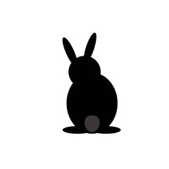 the black hare is sitting with his back turned