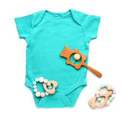 Baby clothes with toys on white background