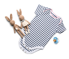 Baby clothes with toys and pacifier on white background