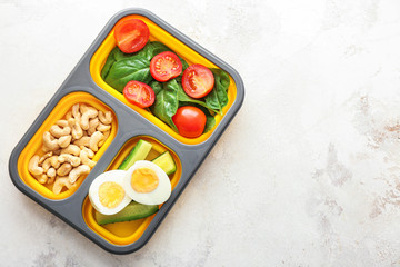 School lunch box with tasty food on table