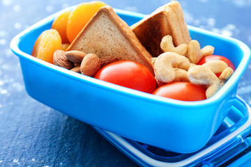 School lunch box with tasty food on table