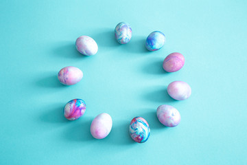 Circle of Easter eggs on a colored isolated background.