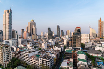 Fototapeta premium Aerial cityscape of picturesque Bangkok at daytime from rooftop. Panoramic skyline of the biggest city in Thailand. The concept of metropolis.