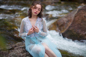 The Tale of the Mermaid. Tale of the River Nymph. Girl in a blue dress by the river.