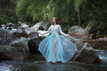 The Tale of the Mermaid. Tale of the River Nymph. Girl in a blue dress by the river.