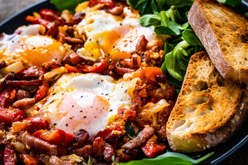 Shakshuka - fried eggs with bacon and vegetables