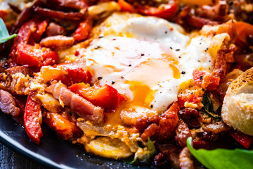 Shakshuka - fried eggs with bacon and vegetables