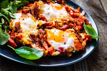 Shakshuka - fried eggs with bacon and vegetables