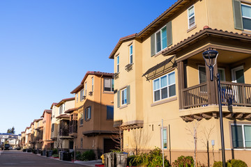 Fototapeta na wymiar Exterior view of a row of identical townhouses; Sunnyvale, San Francisco bay area, California