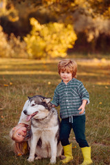 Funny little couple kids and dog together as friends as love of animals concept. Little kids walking together with their pet dog outdoors.