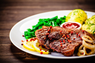 Grilled steak with boiled potatoes and vegetables