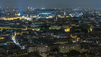 Aerial Night timelapse view of Paris City and Seine river shot on the top of Eiffel Tower