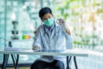 Doctor holding Syringe injection and Vaccine, Prevention, immunization and treatment from corona virus infection (Corona virus outbreaking in Wuhan, China. 
