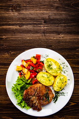 Grilled steak with boiled potatoes and vegetables