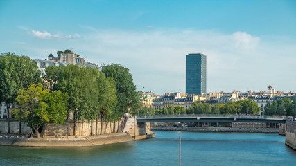 Obraz premium Embankment of the river Seine near Notre Dame with Saint-Louis bridge timelapse.