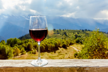 glass of wine in mountains - obrazy, fototapety, plakaty