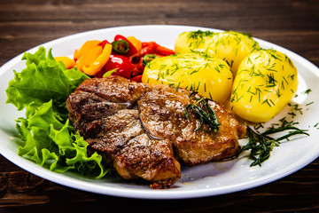 Grilled steak with boiled potatoes and vegetables