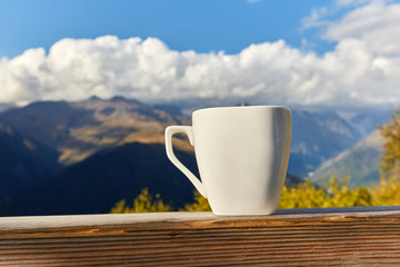 cup on a background of mountains