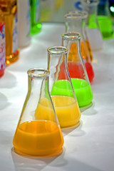 rainbow liquid glass container heap closeup, chemical perfume substance diversity