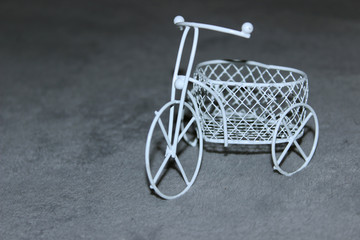 Fototapeta na wymiar children's tricycle white toy trunk which contains five euros