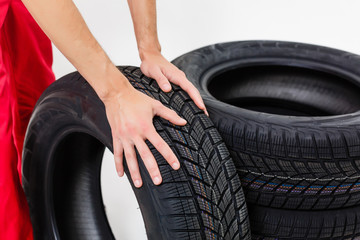 Mechanic Holding Car Tire on a white background