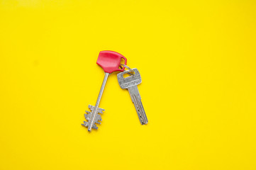 Metal keys on a yellow background