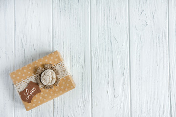 Congratulatory background with a gift box and the inscription love. The basis for a greeting card,...