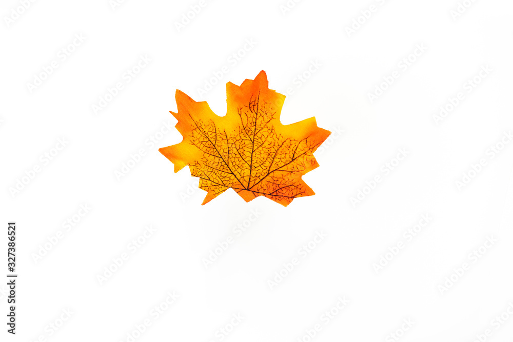 Wall mural plastic artificial maple leaf made from fabric isolated on white background