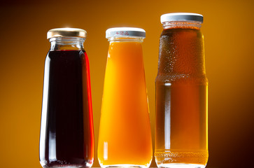 Bottles with cherry, apple and sea buckthorn juice