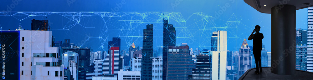 Poster businessman using mobbile phone with smart city and wireless communication network new technology co