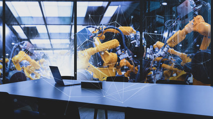 Factory Industrial Engineer office with automation robot arms machine in intelligent factory industrial on real time monitoring system software.Digital future manufacture in meeting room.