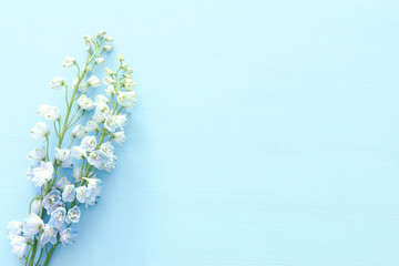 spring bouquet of blue flowers over blue wooden background. top view, flat lay