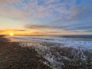 Beatiful sunrise at beach with wave tramore ireland