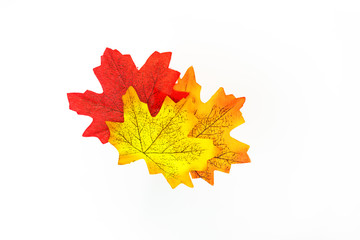 plastic artificial  maple leaf made from fabric isolated on white background