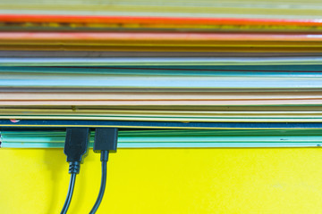 Numerous books connected by data cable. E-book concept.