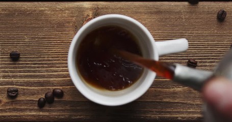 Top view of coffee pour into cup from big coffee maker - Powered by Adobe