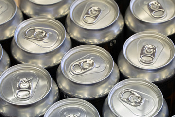 Many new aluminium cans of drink . Drinks manufacturing concept and mass production