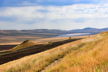 Fototapeta premium Georgian steppe landscape on the way East from Tbilisi to the monastery complex David Gareji.