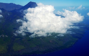Volcano peaks through heavy clouds