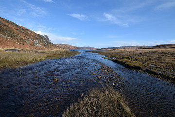 Mountain stream flowing into Loch Tarbert Isle of Jura Scotland