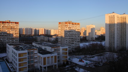 Scool and multi-storey residential buildings with in the Moscow district of Konkovo on a winter morning in the sun rays