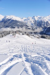 Winter scenery with ski track and snowy mountain background 