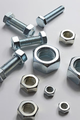 Bolts and screw-nut of different sizes. Concept. White background.