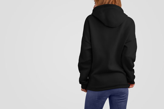 Mockup clothes series. Gracile beaty woman in a black hoodie and blue pants isolated on the blank studio backgrounds.